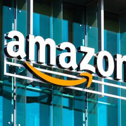 An Amazon logo sign hanging in front of a building
