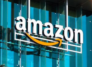 An Amazon logo sign hanging in front of a building