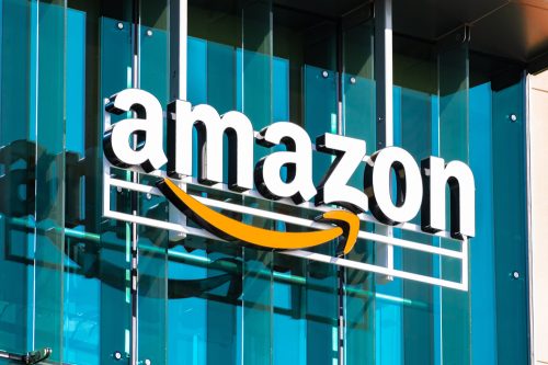 An Amazon logo sign hanging in front of a building