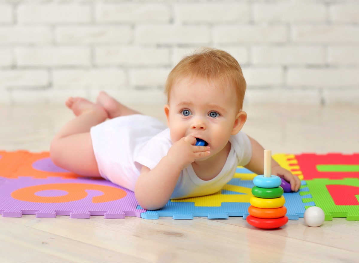 baby putting toy in mouth