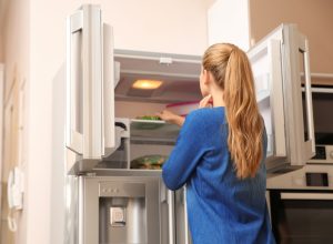 Woman looking in the freezer