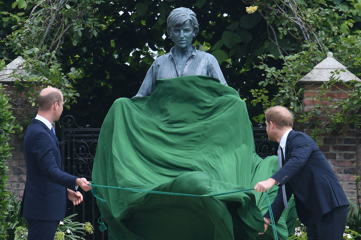 Britain's Prince William, Duke of Cambridge (L) and Britain's Prince Harry, Duke of Sussex unveil a statue of their mother, Princess Diana at The Sunken Garden in Kensington Palace, London on July 1, 2021
