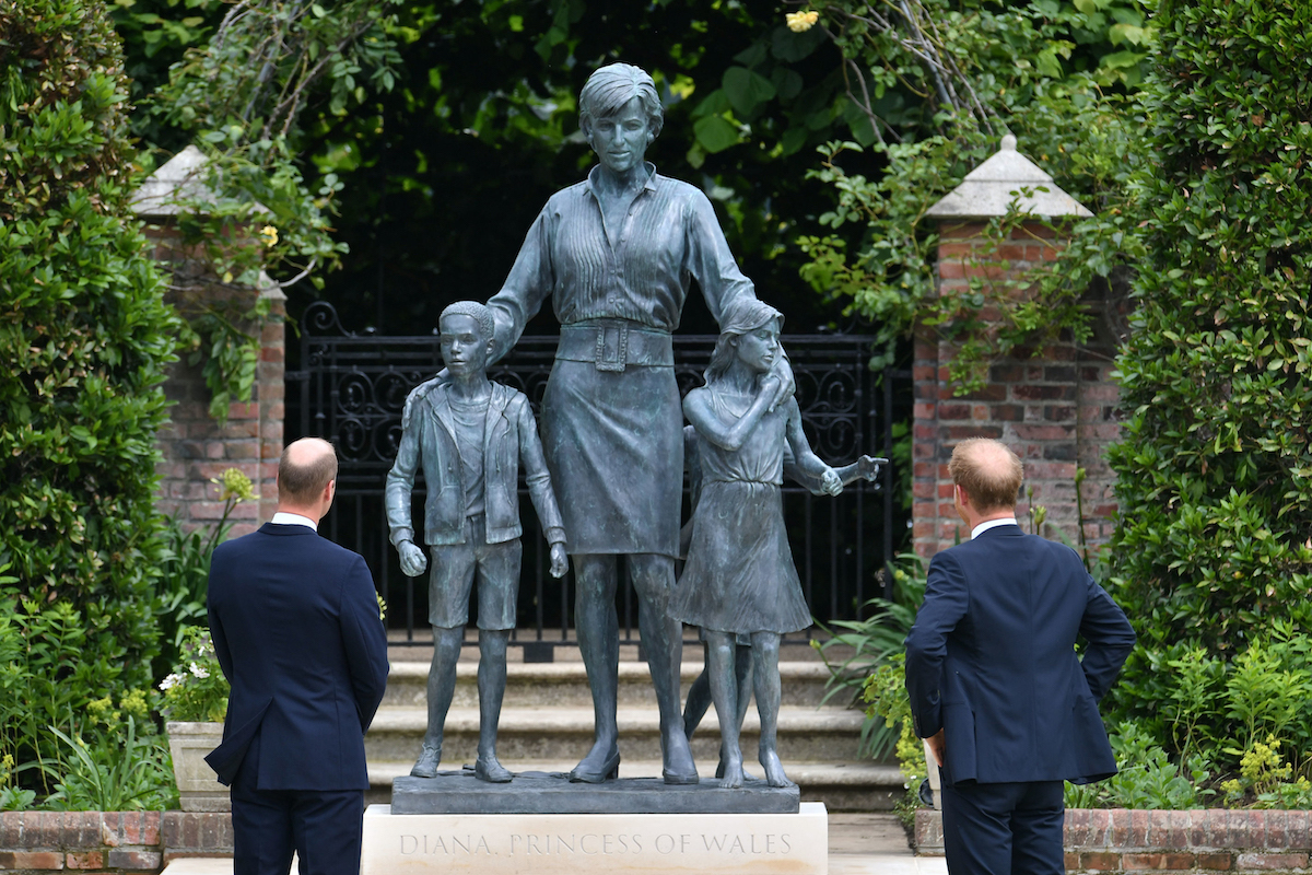 The Duke of Cambridge (left) and Duke of Sussex look at a statue they commissioned of their mother Diana, Princess of Wales, in the Sunken Garden at Kensington Palace, London, on what would have been her 60th birthday.