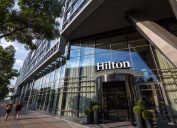 BELGRADE, SERBIA - AUGUST 14, 2018: Hilton logo on the entrance their newly opened hotel of Belgrade, during the afternoon. Hilton is one of the biggest brands of luxury hotels