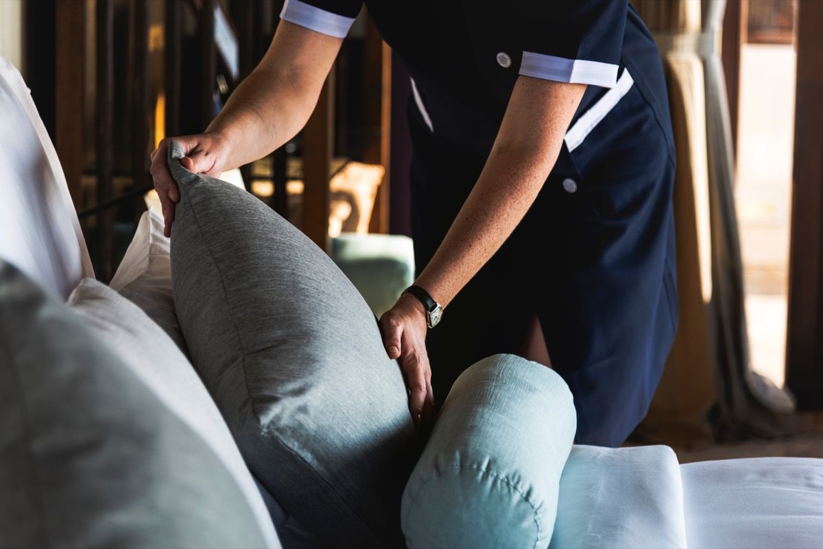 Housekeeper cleaning a hotel room