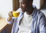 A young man drinking a cup of coffee