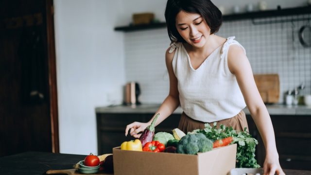 woman received a full box of colourful and fresh organic groceries