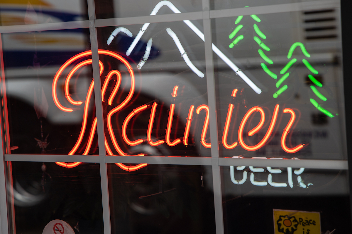 Bright neon Rainier Beer sign in the window of a local pub in Glacier, WA