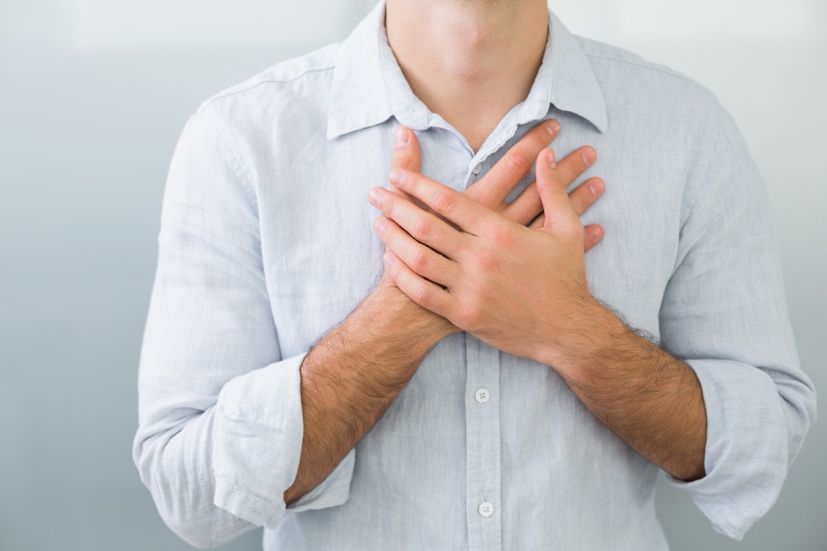 Close up mid section of a young man with chest pain