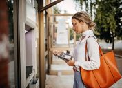 Women using ATM machine to withdraw money