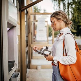 Women using ATM machine to withdraw money