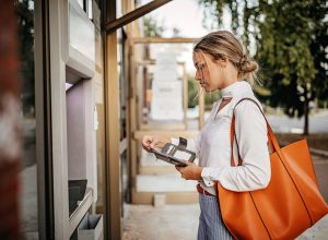 Women using ATM machine to withdraw money