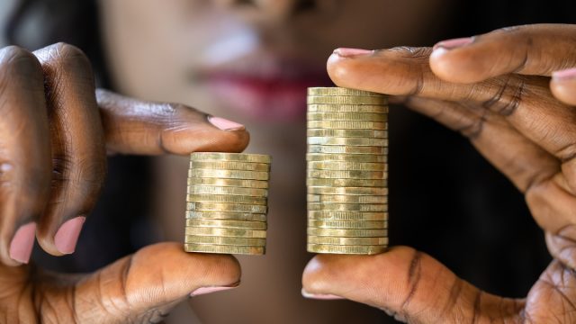 Woman holding coins to show wage gap