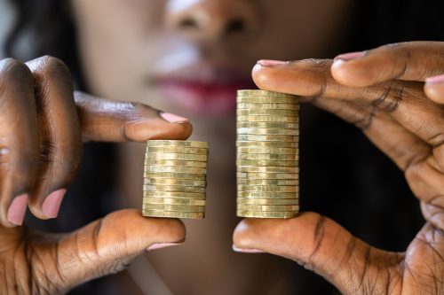 Woman holding coins to show wage gap