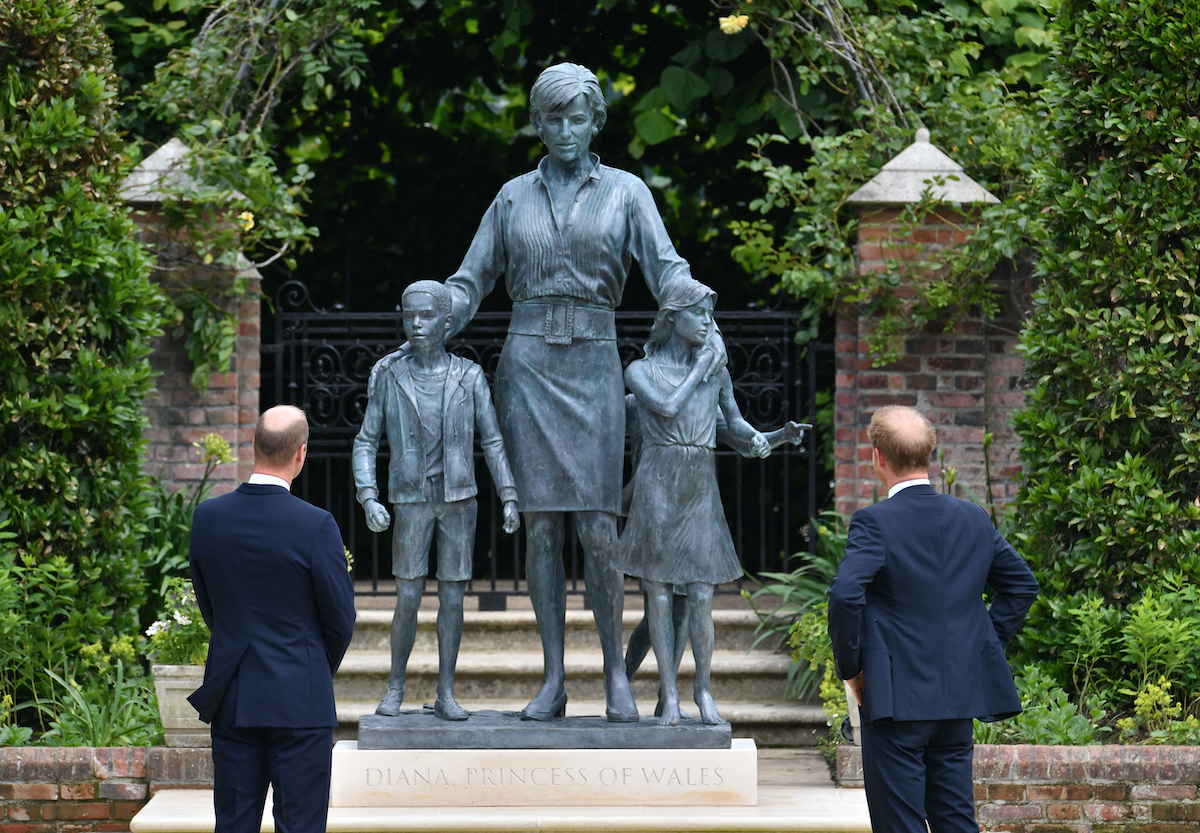 The Duke of Cambridge (left) and Duke of Sussex look at a statue they commissioned of their mother Diana, Princess of Wales, in the Sunken Garden at Kensington Palace, London, on what would have been her 60th birthday.