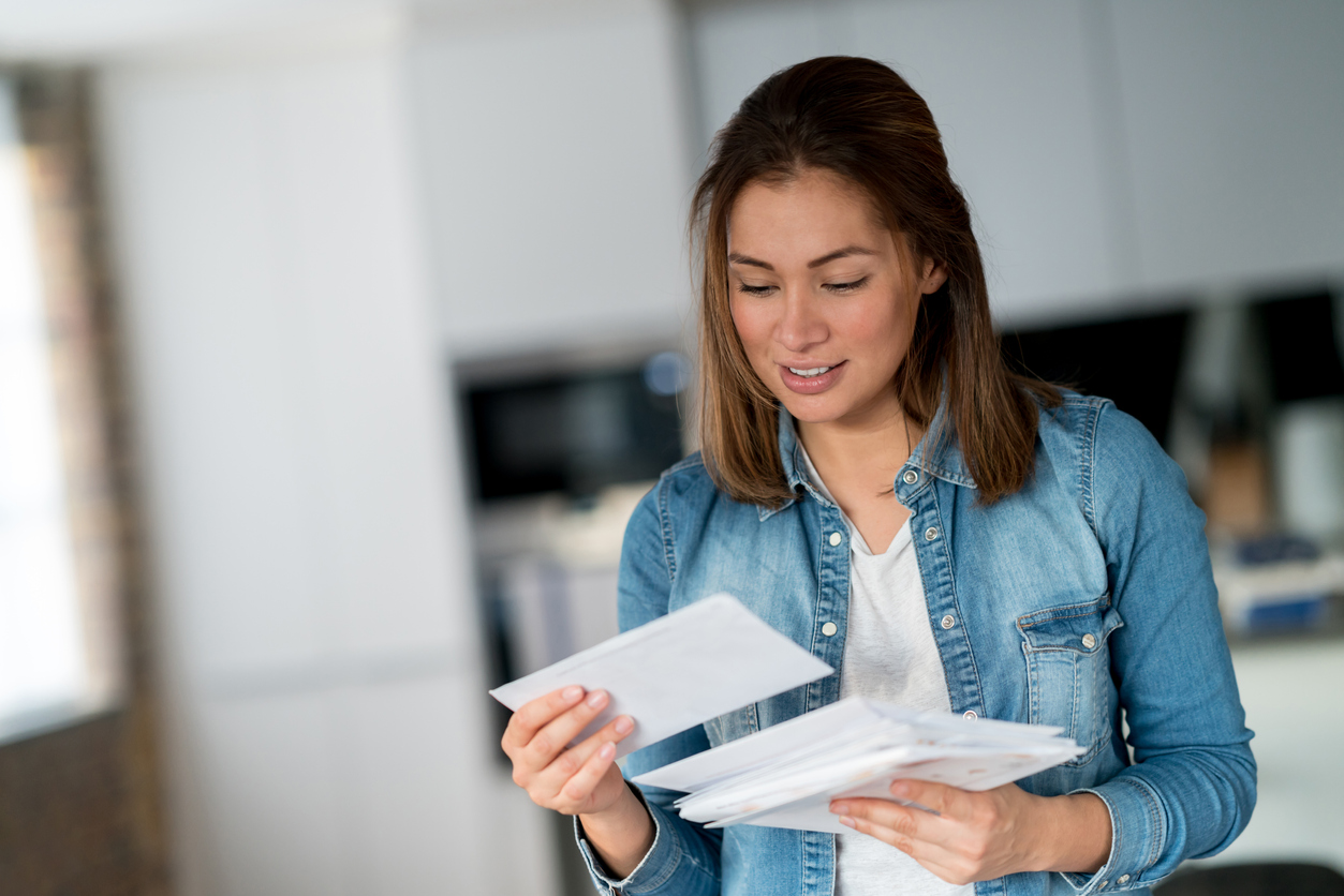A woman checking her mail in her home