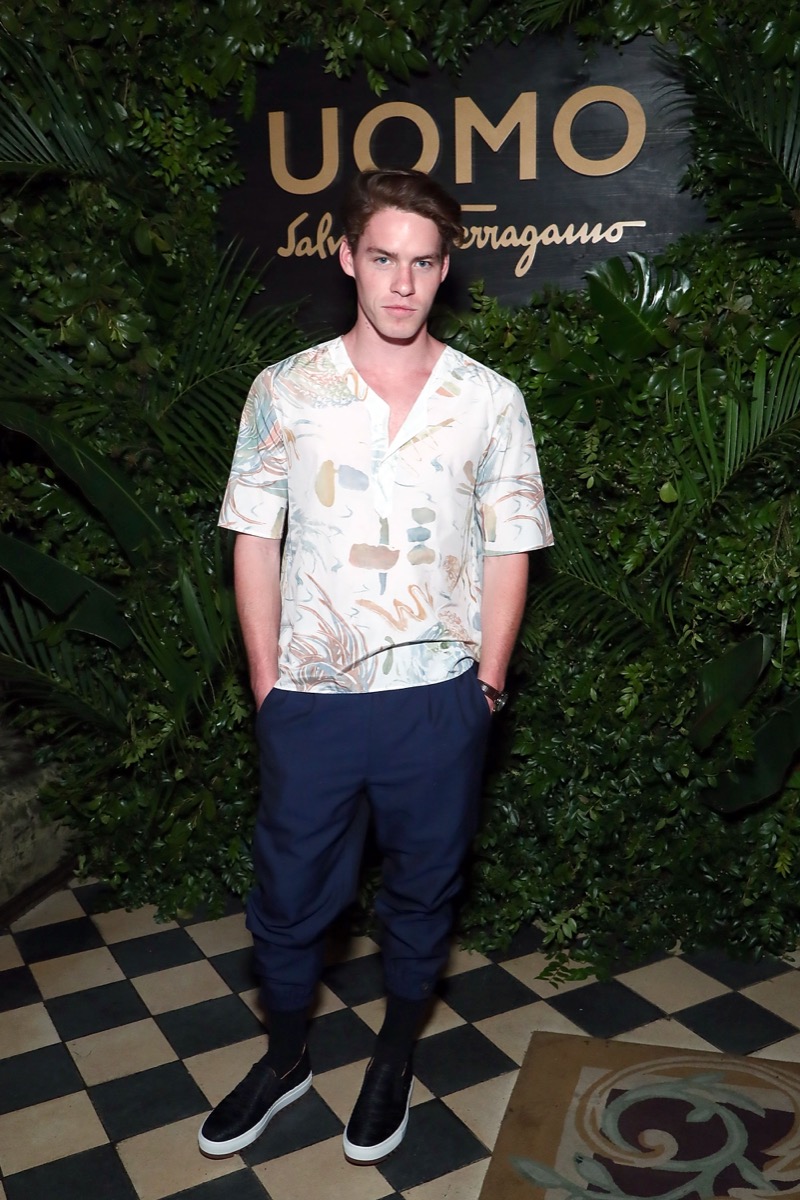 Tyler Clinton in white shirt and blue pants backstage at ferragamo show
