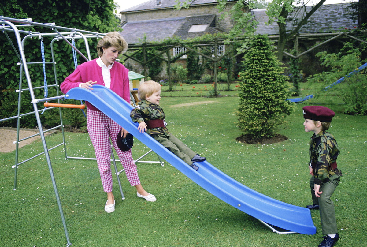 Princess Diana At Highgrove With Prince William And Prince Harry Dressed In Miniature Parachute Regiment Uniforms And Playing On Their Slide In The Garden
