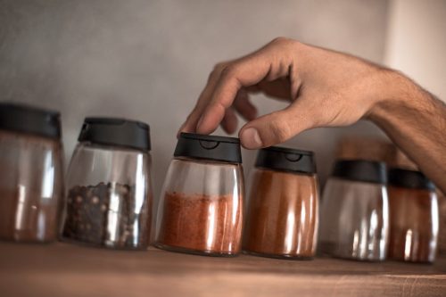 close up. a man chooses spices in the kitchen