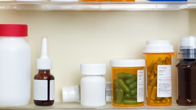 medicine cabinet full of prescription bottles and jars