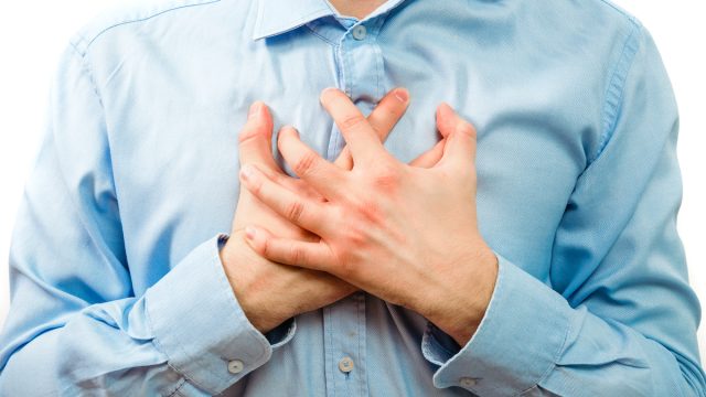 Man holding his hands over heart
