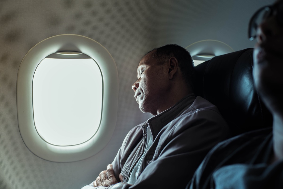 Man sleeping on plane