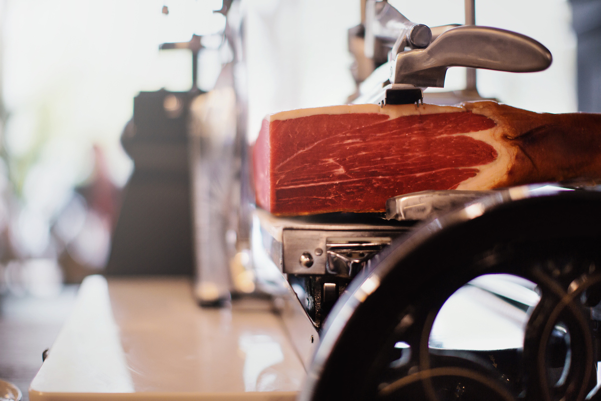Meat slicer with prosciutto, an Italian meat