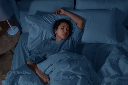 woman sleeping in bed at home at night