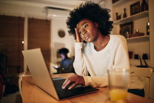 woman doing freelance work on a laptop and struggling with a problem