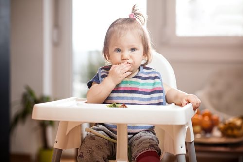 Baby in highchair with hiccups