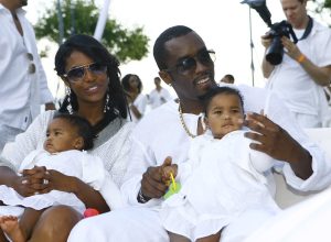 Kim Porter, Diddy, and their twin daughters at his white party in the Hamptons in September 2007