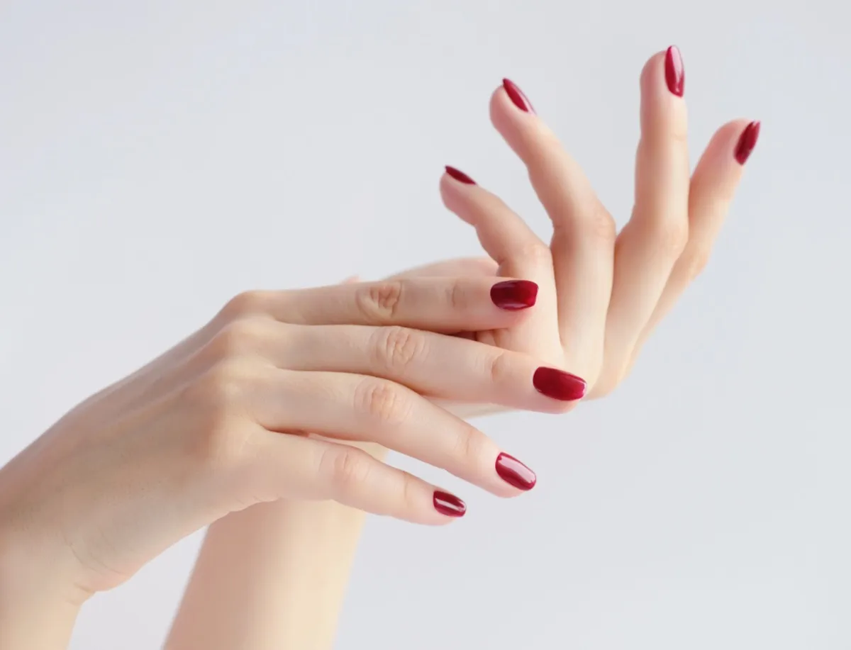 Closeup on woman's hands with red manicure
