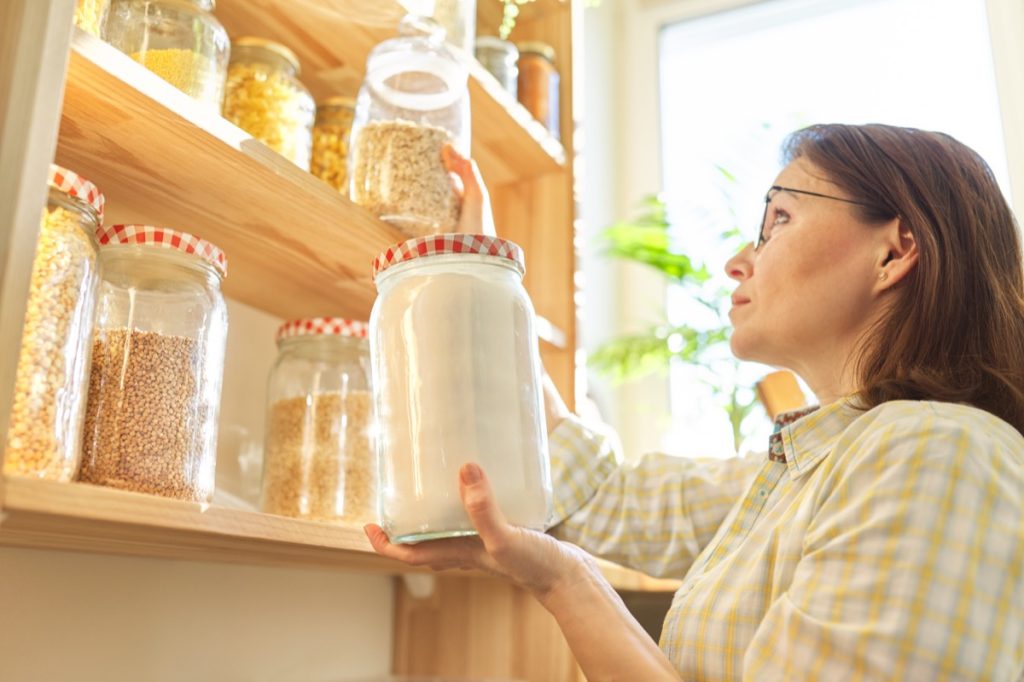 Lady inspecting pantry items