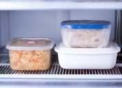 three food containers in a freezer