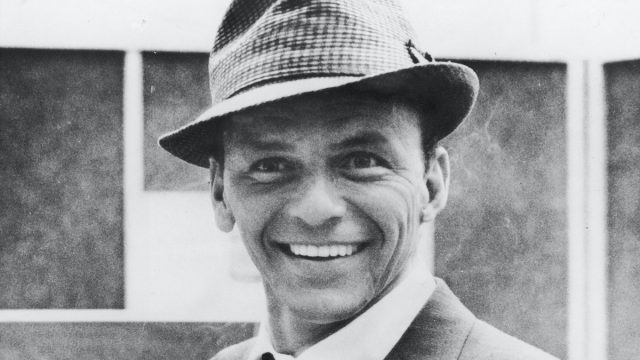 American singer and actor Frank Sinatra smiles at recording studio, 1950s.