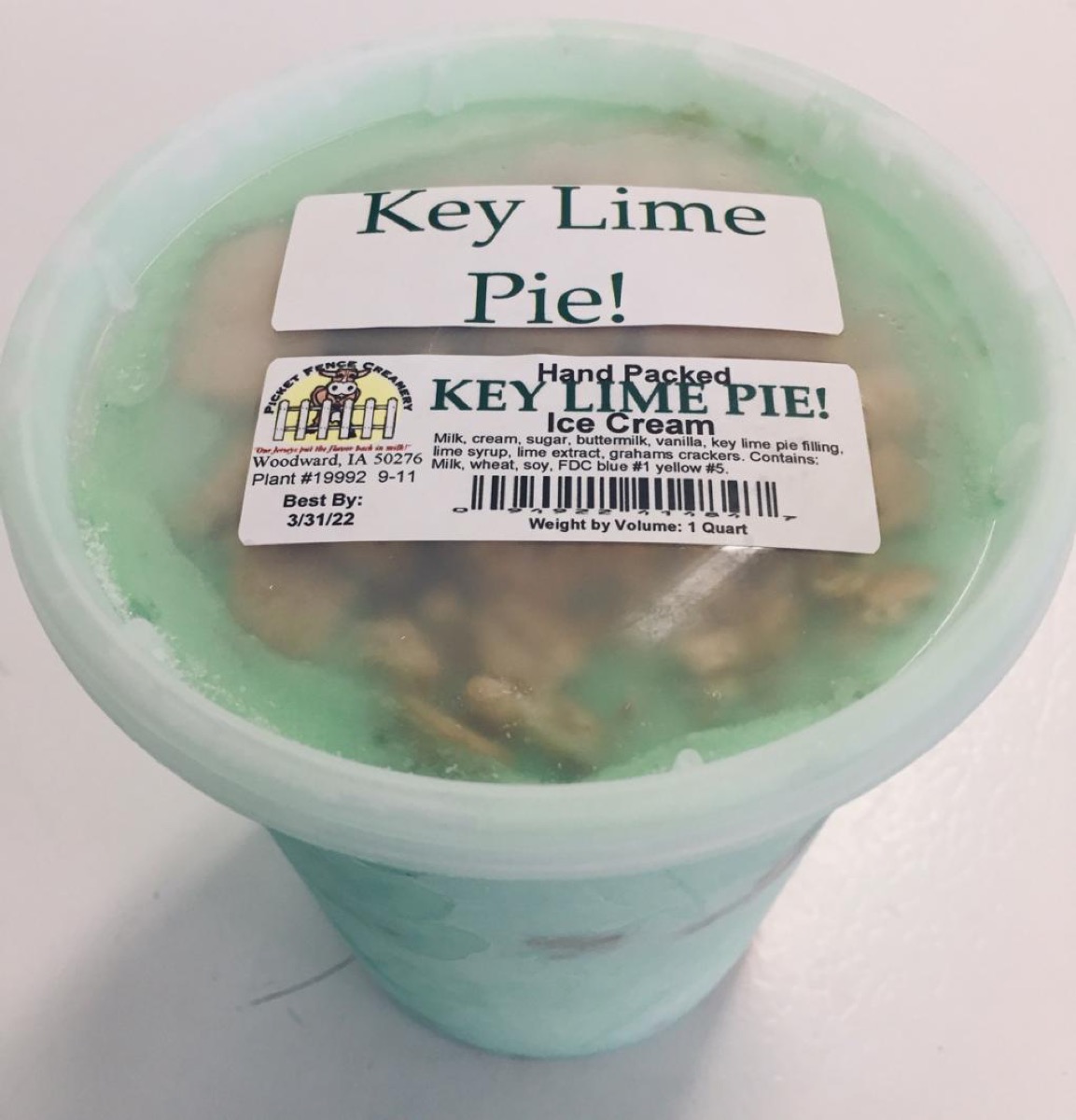 plastic quart container full of bright green key lime pie ice cream
