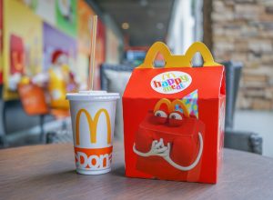 BANGKOK - OCTOBER 10 : Happy meal set ,in soft focus, with blurred Ronald Mcdonald at McDonald's restaurant on October 10, 2017 in Bangkok, Thailand