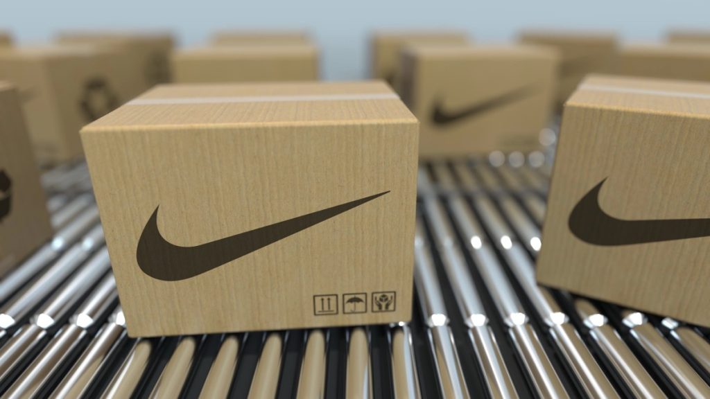 Carton boxes with nike logo move on roller conveyor. realistic 3D rendering