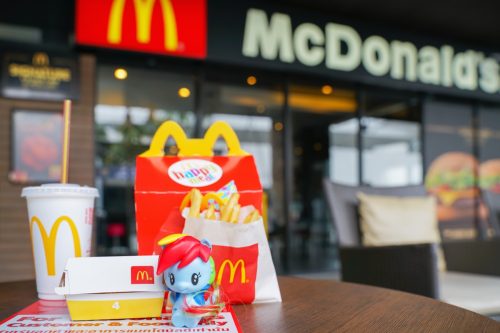 BANGKOK,THAILAND - JUNE 25,2018 : Rainbow dash, character cartoon from my little pony with Happy meal set on desk ,in soft focus, at McDonald's restaurant