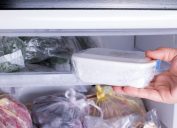 person removing container from freezer
