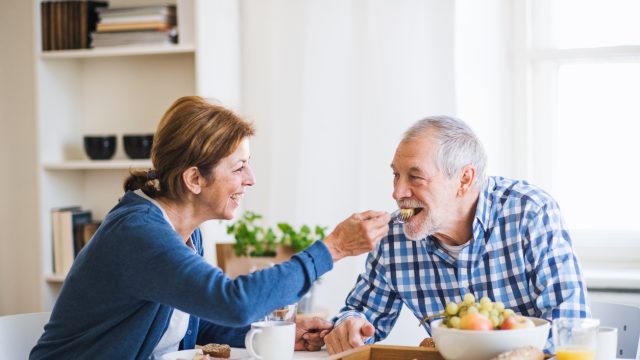 A senior couple eating breakfast