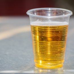 Plastic cup of cheap beer