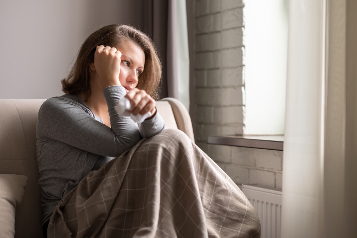 Woman feeling sick on couch