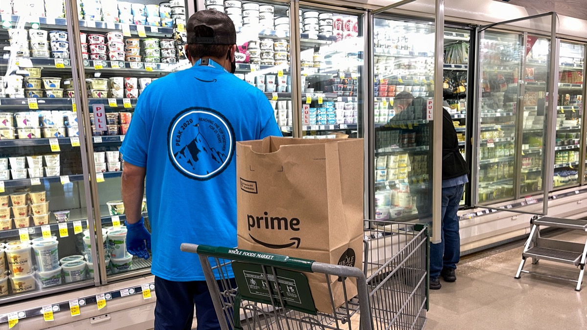 Orlando, FL USA - January 24, 2021: Amazon Prime Fresh employees shopping at a Whole Foods grocery store selecting food for for people to have delivered to their homes.