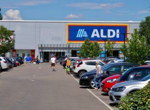London,UK/June 16,2020:Customers walking on the parking area of Aldi supermarket. Aldi is the common brand of two German based global family-owned discount supermarket chains.