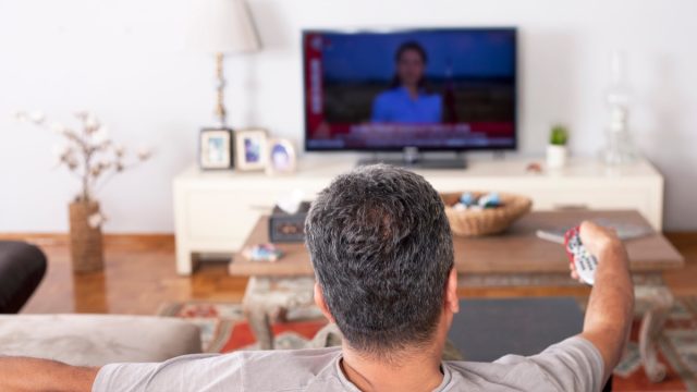 Man watching TV on couch