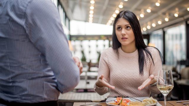 Women look at waiter and pointing at her food