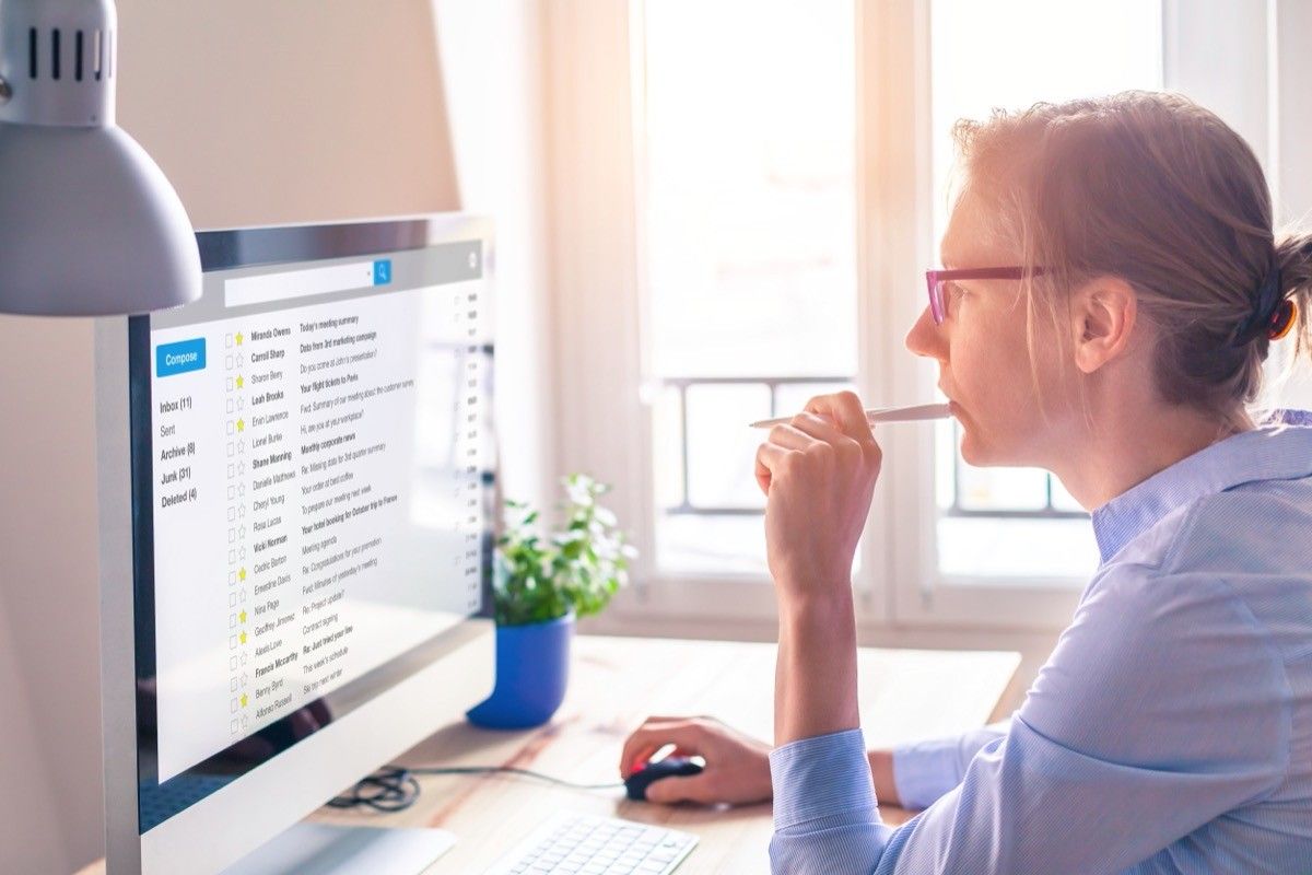 woman reading email at desk