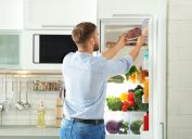 Man taking meat from fridge