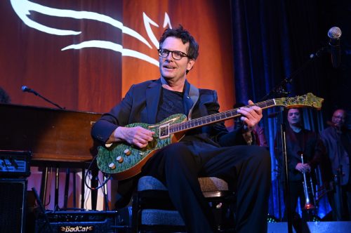 Michael J. Fox playing guitar at A Funny Thing Happened on the Way to Cure Parkinson's in 2019